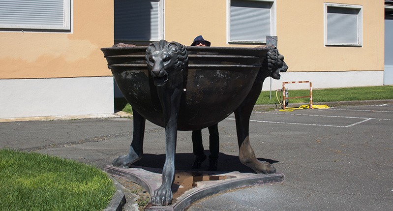 a person posing with the lion headed bowl