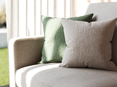 Sofa detail with upholstered seat and decorative pillows