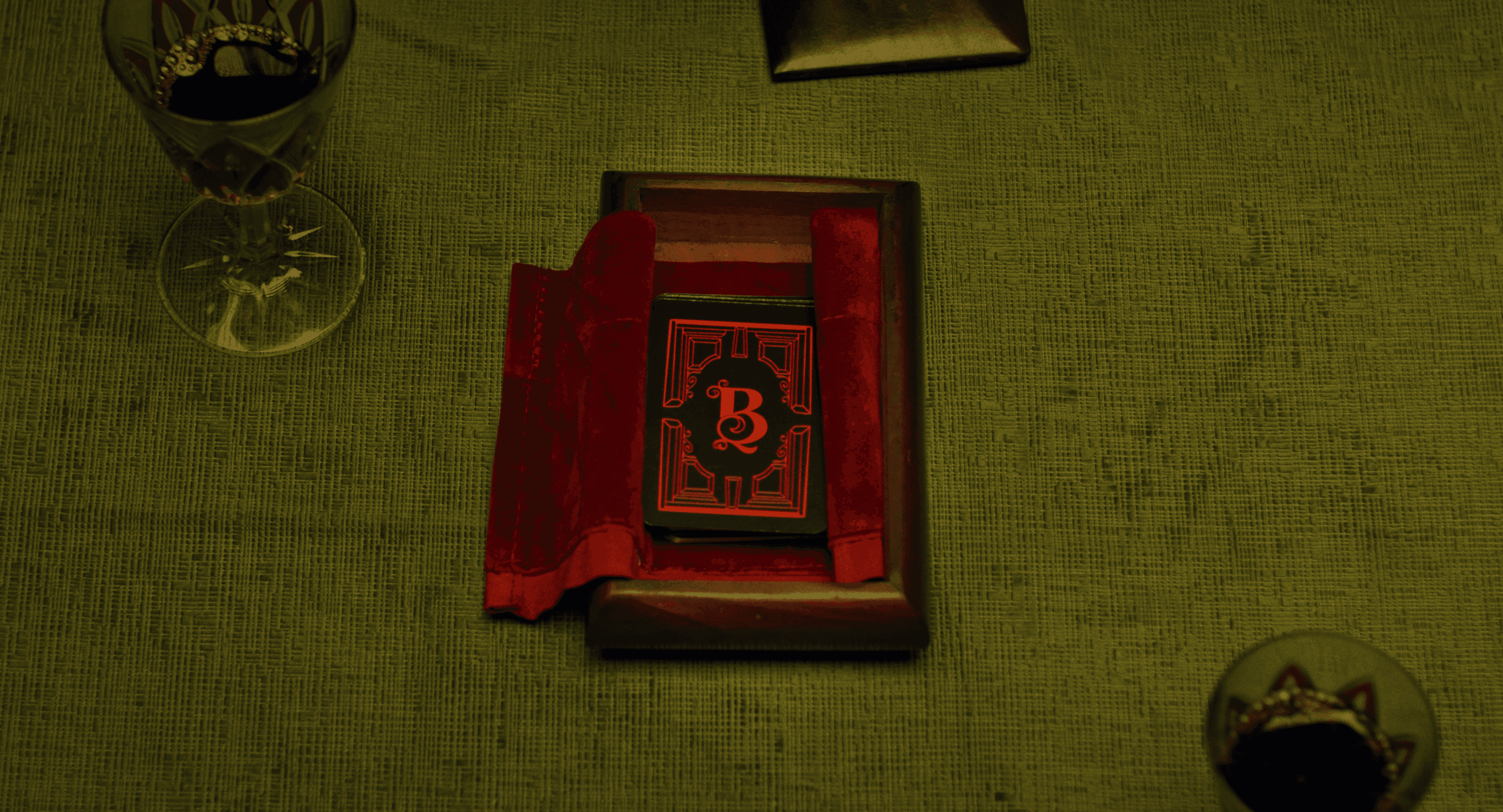 View of the French countryside through a stone villa’s open living room, with sofas and trees framing the scene