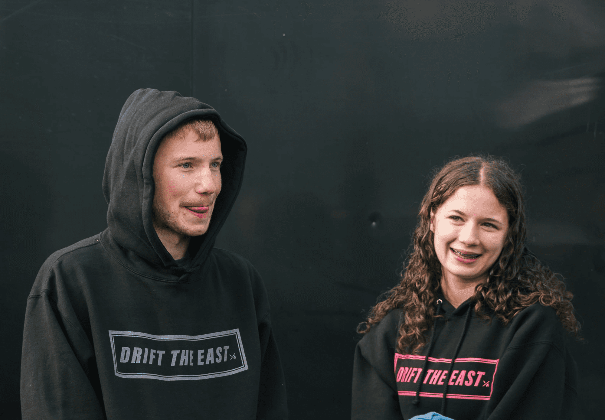 nfinity pool blending into the ocean view, minimalist sun loungers in soft neutral fabric, curved architecture