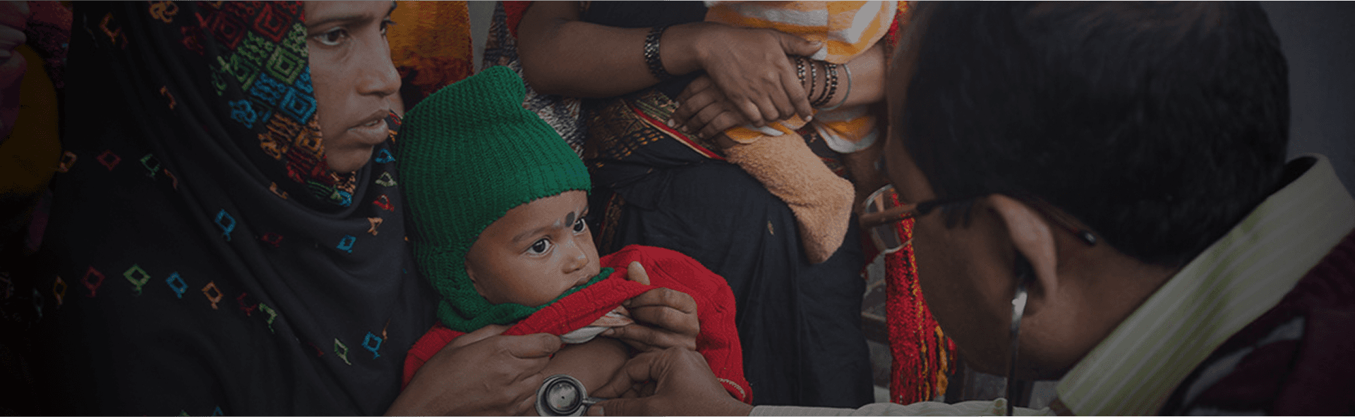 person sitting on grass and using phone