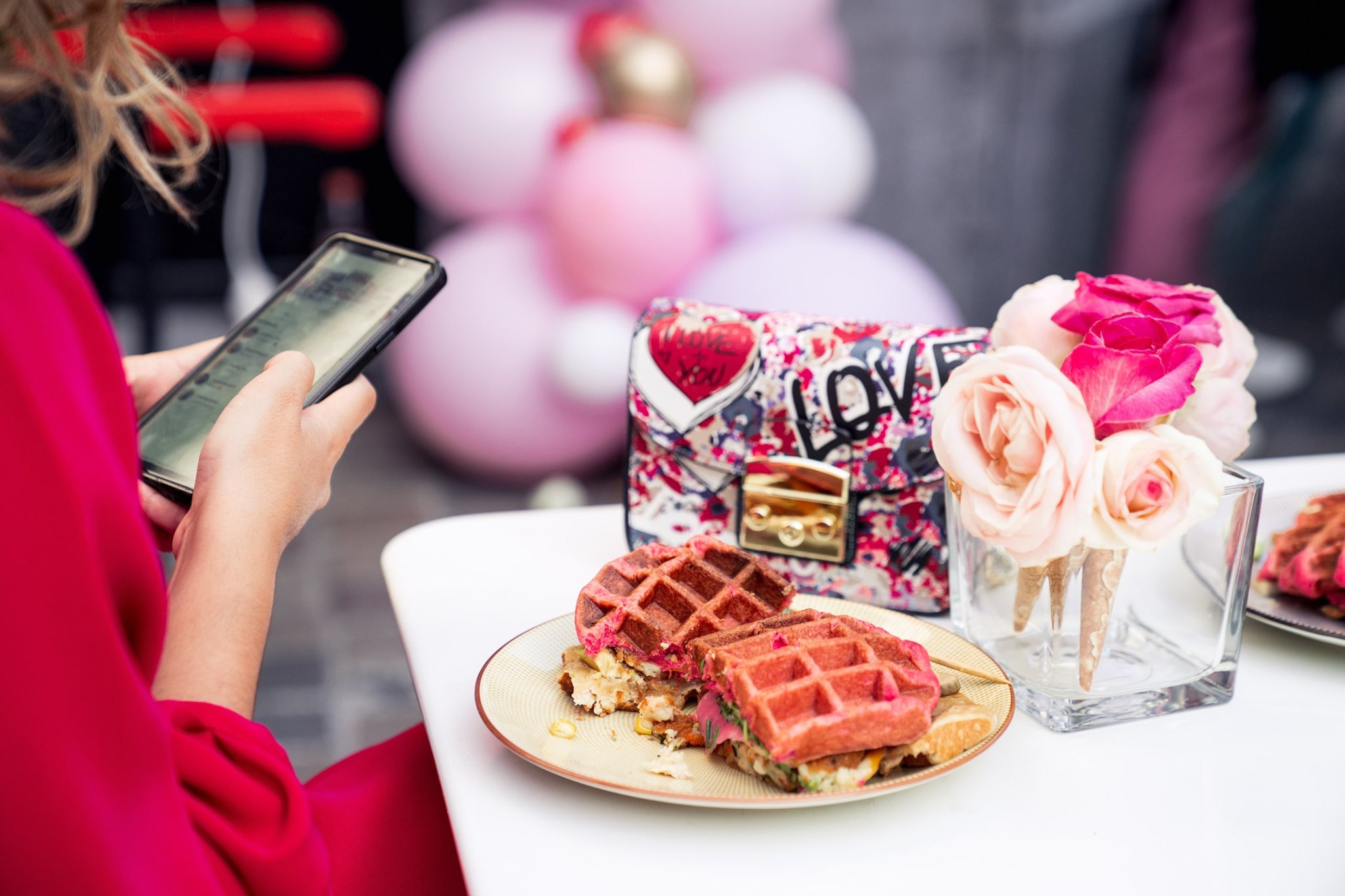 Shiny metallic silver foil pouch lying flat, printed with a large black outline of a smiley face, all set against a bright orange backdrop.