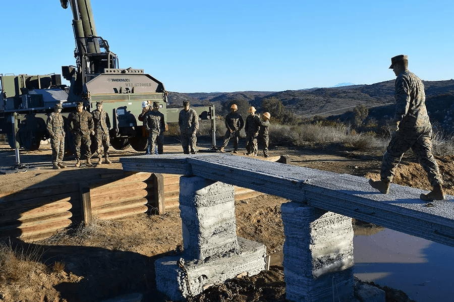 1st Marine Logistics Group at Camp Pendleton in California walking across a 3D printed concrete footbridge