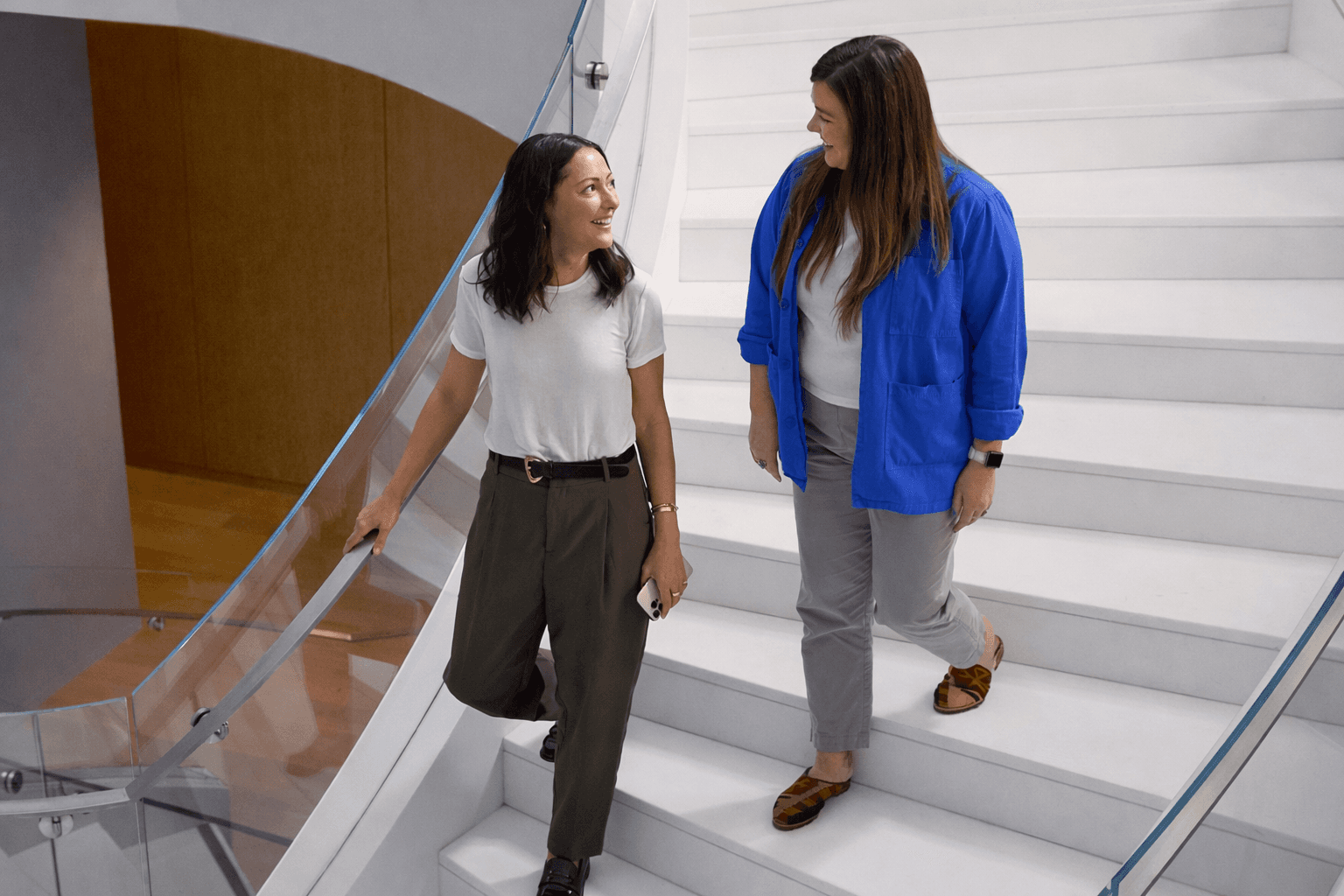 a woman wearing headphones and holding a cell phone