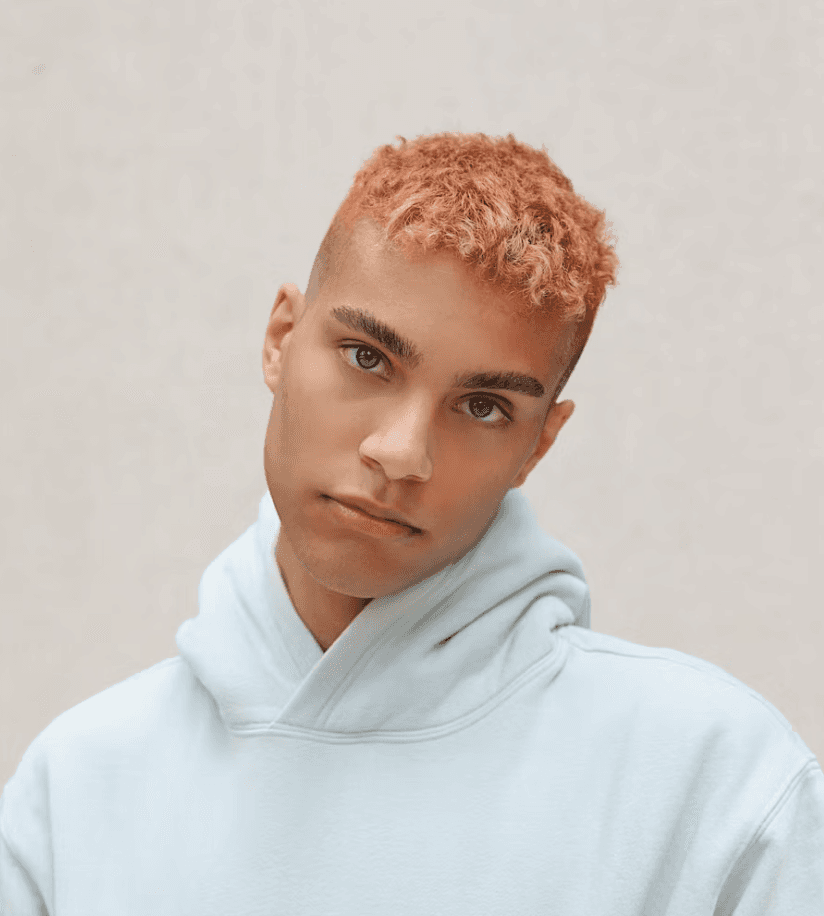 a man with a goatee smiles at the camera