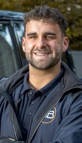 Portrait of a person in dark clothing speaking on a phone