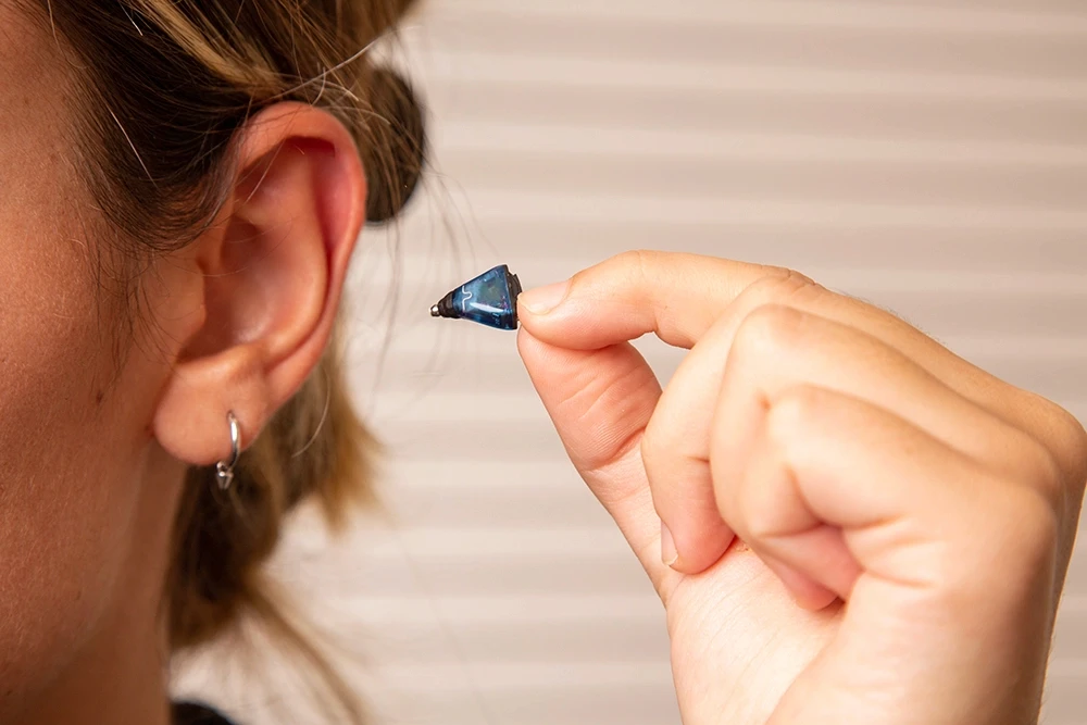 Doctor checking a male patient's hearing