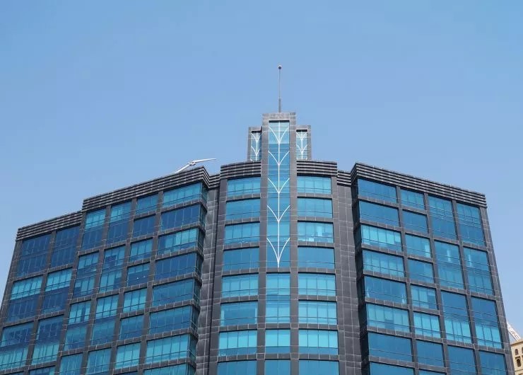 Distant street view capturing the scale of Apricot Tower within its urban corporate surroundings.