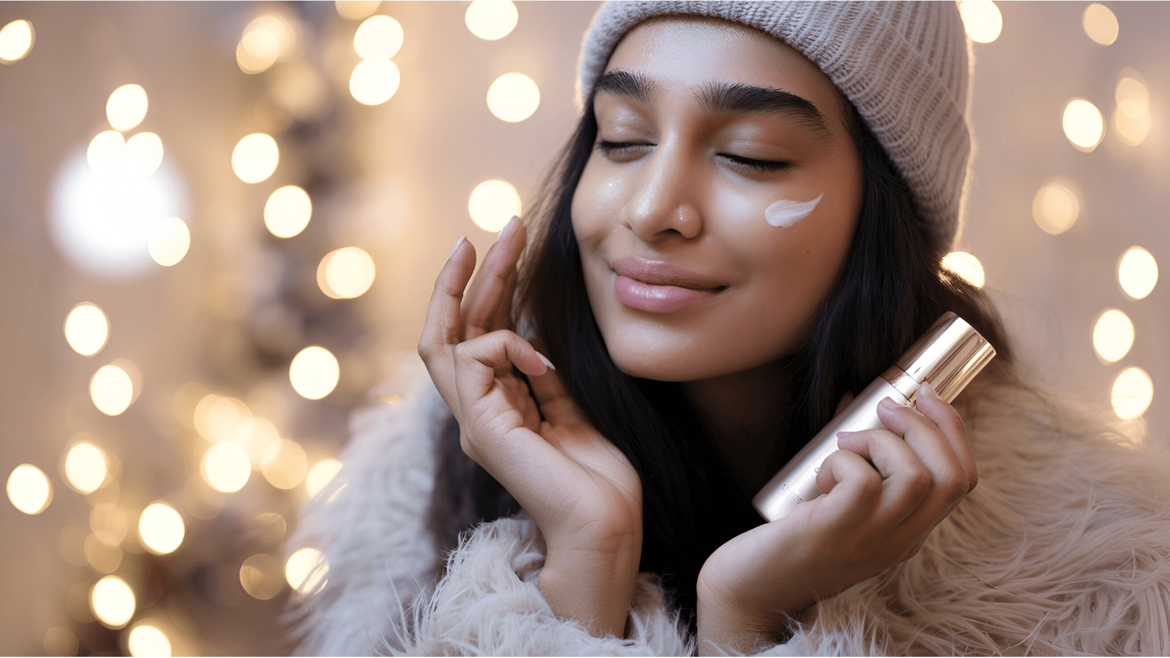 A woman wearing a cozy winter hat and fur-lined coat, gently applying moisturizer to her face against a festive backdrop of warm lighting, showcasing winter skincare tips for glowing skin.Nivea Soft Light Moisturizer Cetaphil Moisturizing Cream Pond’s Cold Cream Plum E-Luminence Deep Moisturizing Crème Himalaya Nourishing Skin Cream Vaseline Intensive Care Cocoa Glow Dove DermaSpa Winter Care Lotion Mamaearth CoCo Body Lotion L’Oréal Paris Revitalift Hyaluronic Acid Serum The Ordinary Hyaluronic Acid 2% + B5 Eucerin Advanced Repair Cream Kiehl’s Ultra Facial Cream Nivea Cocoa Butter Body Lotion Vaseline Aloe Soothe Lotion L'Oréal Paris Hydra-Total 5 Daily Moisturizer Maybelline Baby Lips Biotique Bio Fruit Whitening Lip Balm Lotus Herbals Safe Sun 3-in-1 Matte Sunscreen Neutrogena UltraSheer Dry-Touch Sunscreen Nivea Hand Cream Glycerin & Beeswax The Body Shop Almond Milk Hand Cream Dove Deep Moisture Body Wash Cetaphil Gentle Skin Cleanser Vaseline Healthy White Lightening Lotion L'Oréal Paris Revitalift Brightening Moisturizer Dove Deep Care Body Lotion Burt's Bees Beeswax Lip Balm Vaseline Lip Therapy Innisfree Green Tea Seed Serum Laneige Water Sleeping Mask COSRX Advanced Snail 96 Mucin Power Essence Dr. Jart+ Ceramidin Cream Etude House Moistfull Collagen Cream Sulwhasoo First Care Activating Serum Belif The True Cream Aqua Bomb Skinfood Royal Honey Propolis Enrich Essence Missha Time Revolution The First Treatment Essence Klairs Rich Moist Soothing Cream Pyunkang Yul Moisture Ampoule MISSHA Super Aqua Ultra Hyalron Emulsion Dove Deeply Nourishing Body Wash DOVE Body Love Supple Bounce Body Lotion for Dry Skin DOVE Beauty Cream Bar Imported DOVE beauty Skin whitening cream DOVE Restoring Ritual Body Lotion DOVE Body Love Light Hydration Body Lotion Dove DermaSeries Dry Skin Relief Body Lotion