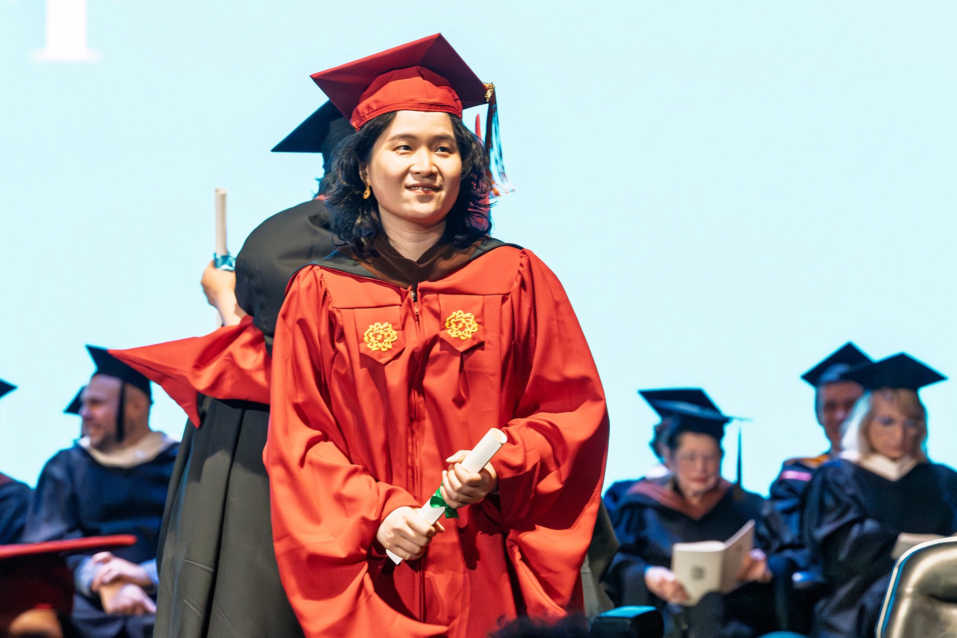 a student on stage getting her diploma