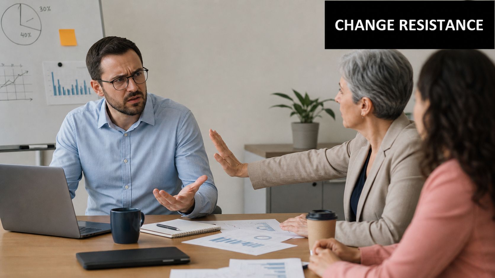 A professional business meeting where a colleague expresses resistance by holding up a hand to a coworker.