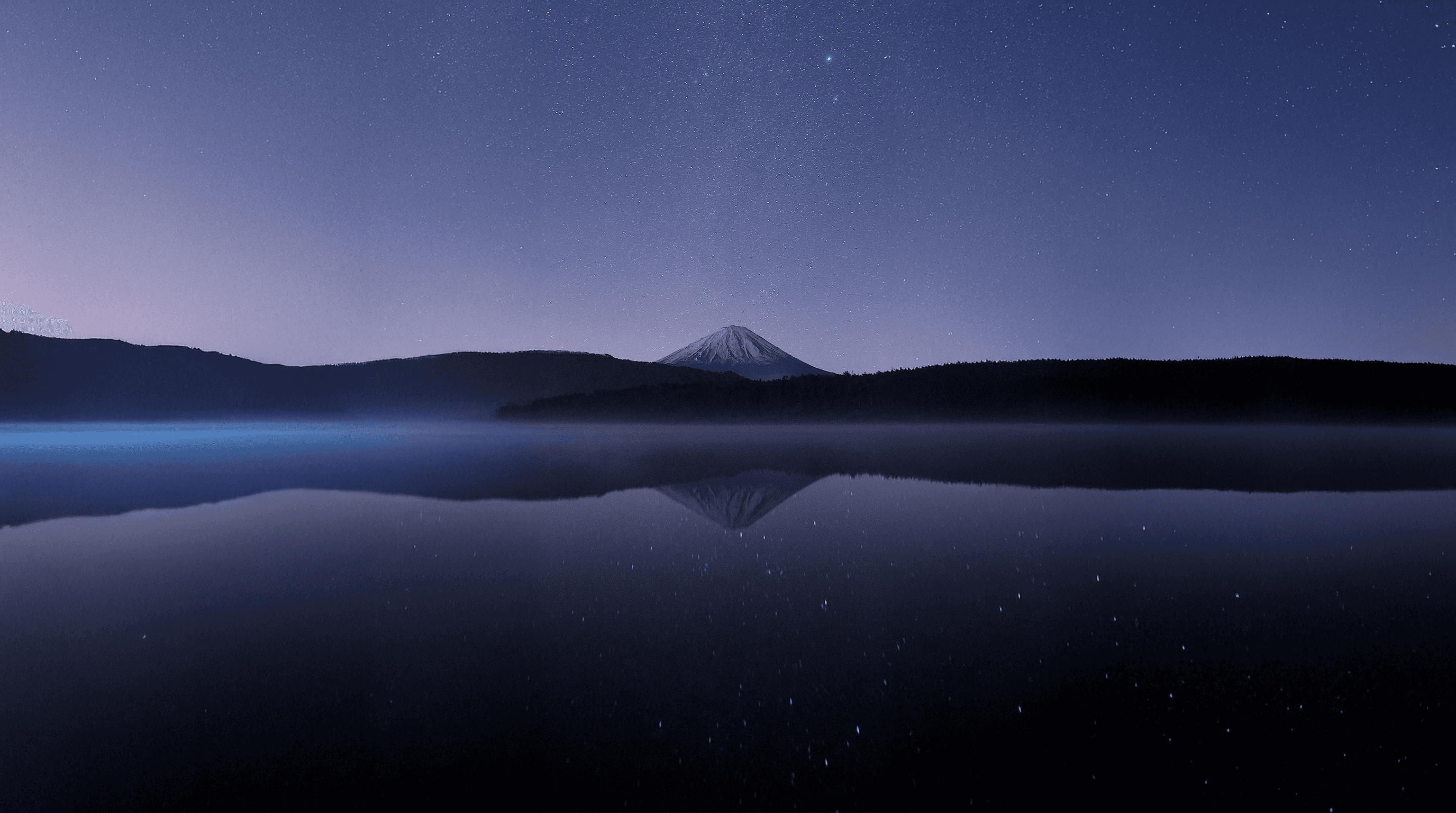 calm body of water near alp mountains during nighttime