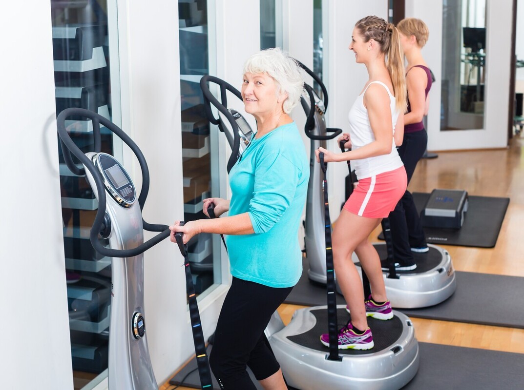 group of people doing a vibration plate weight loss routine at the gym