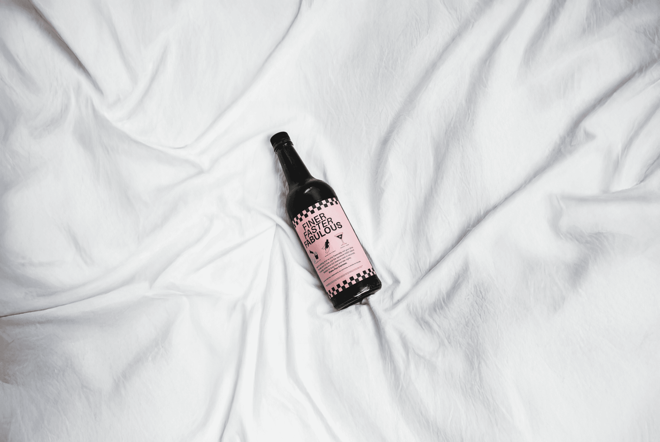 KISSY bottle lying on white sheets