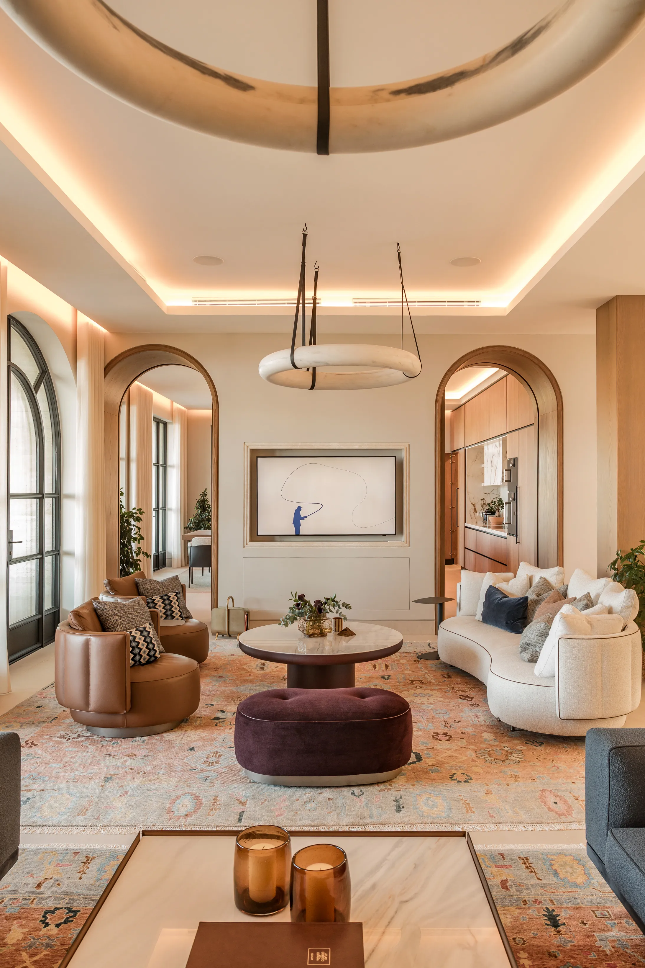 Elegant living room with bespoke furnishings, arched architecture and soft natural tones.