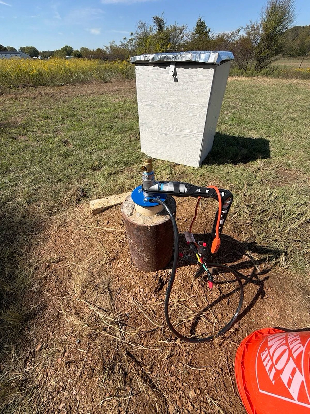 Finished wellhead and well house after a pump replacement