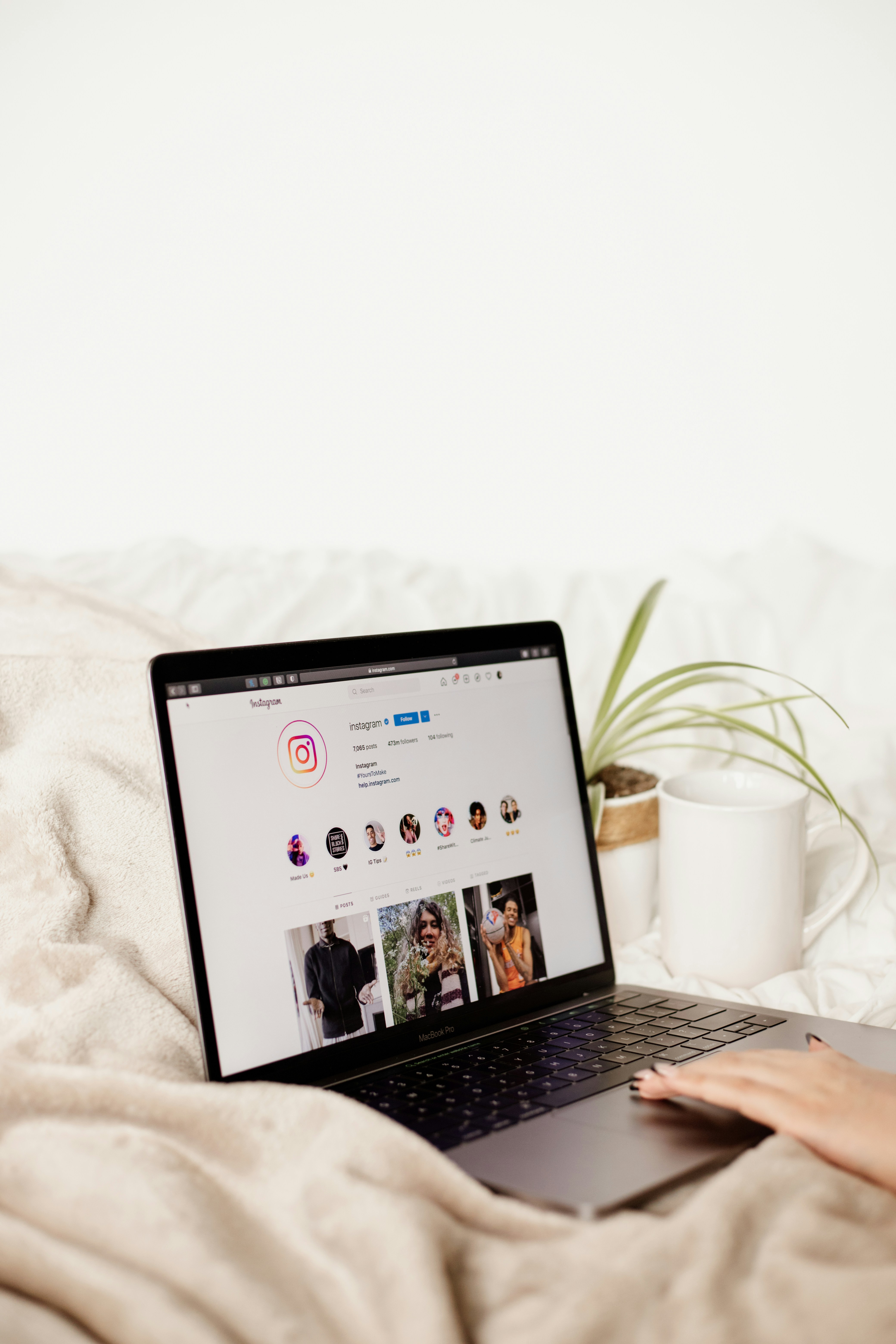a laptop computer sitting on top of a bed
