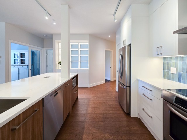 Image of Modern kitchen with white countertops, stainless steel appliances, and design layout by KHD Homes.