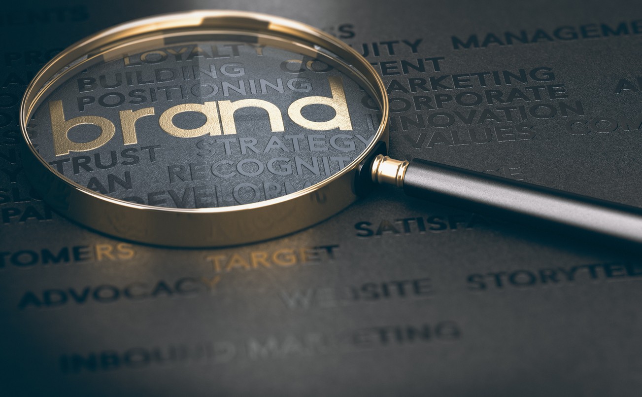 3d illustration of a magnifying glass over golden and black words | How to Name Your Dispensary | Cannabis Marketing Agency