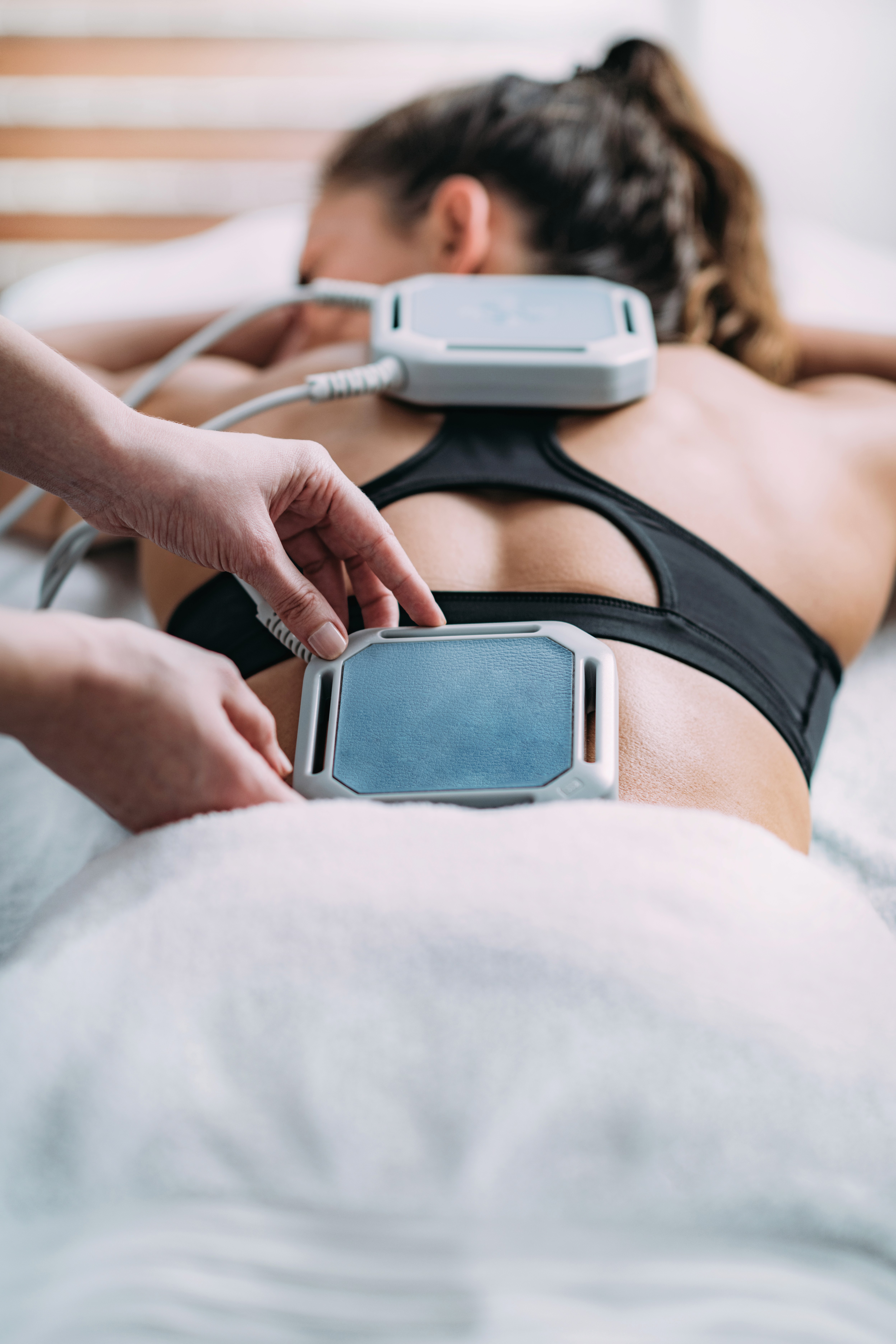 Smiling patient during dental checkup with dentist examining teeth