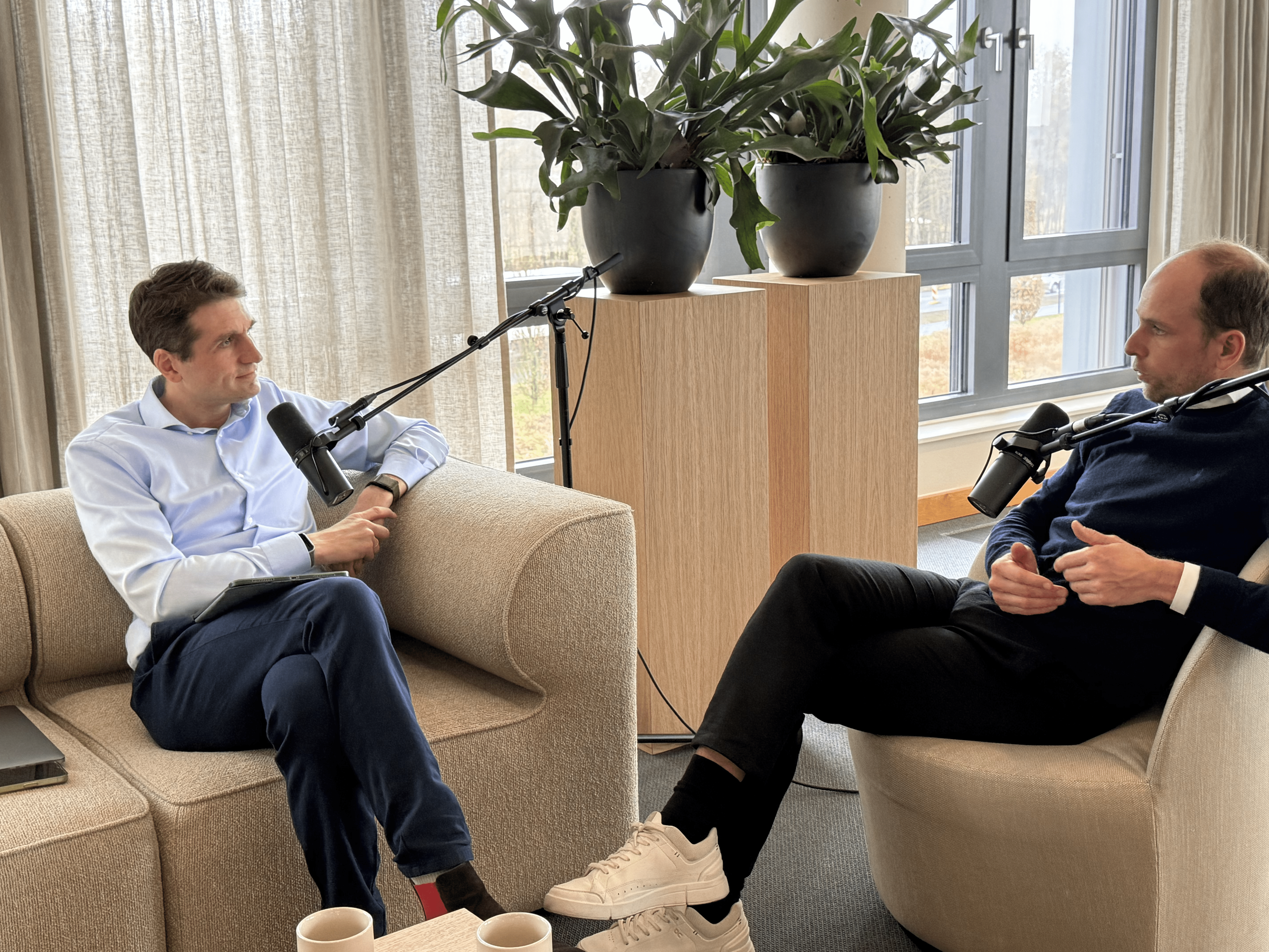 Aerial view of a winding road cutting through rocky terrain and sandy landscape.