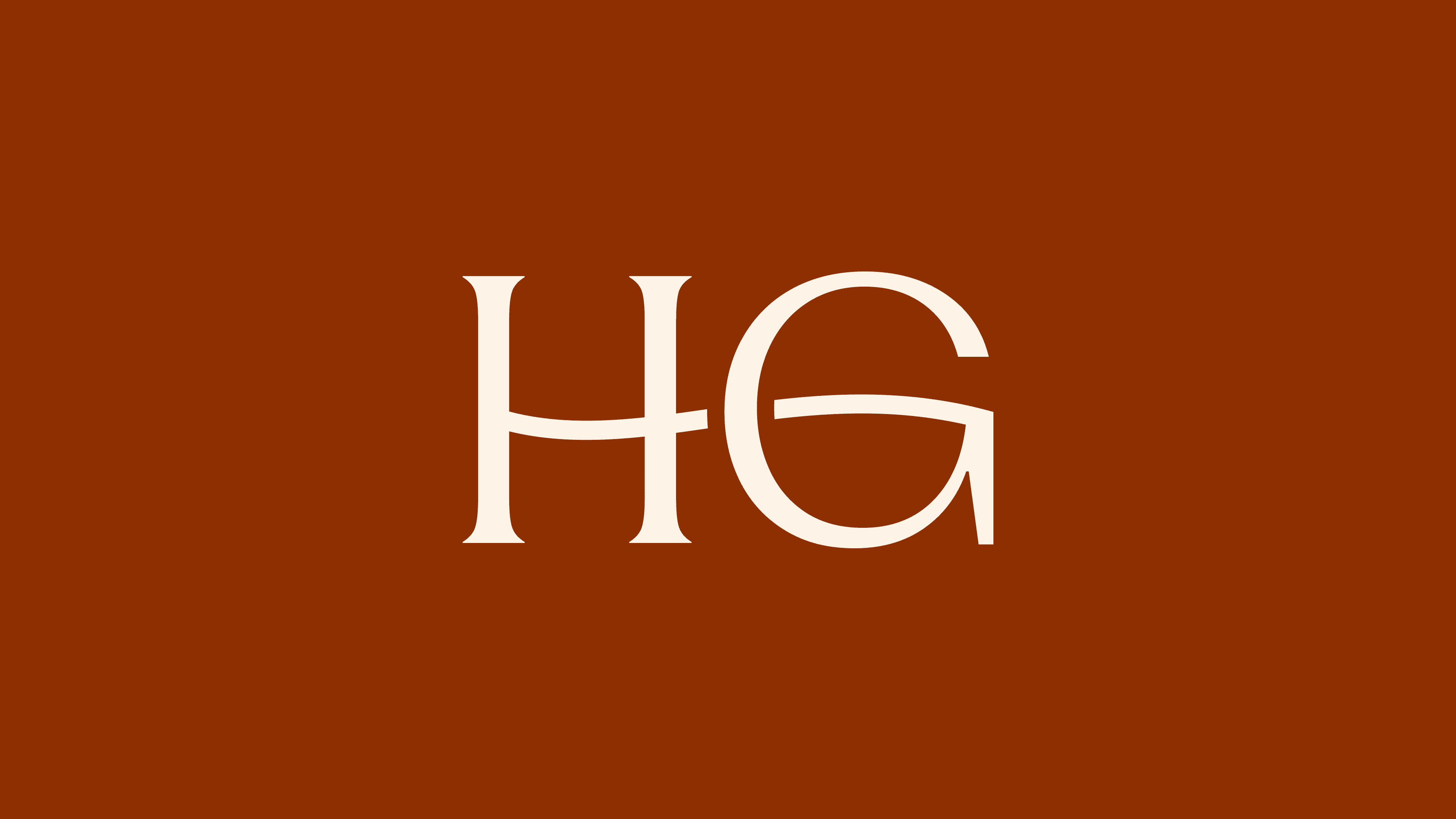 Text in a simple white font reads "HG" on a brown background.