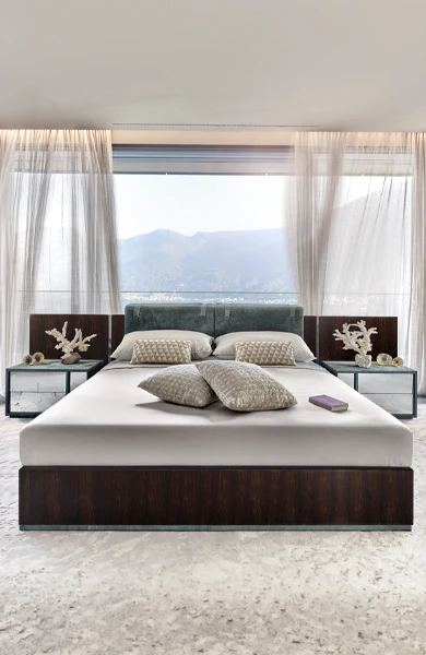 side view of a bedroom (غرف نوم فاخرة) with a contemporary selection of furniture which includes bed with wooden structure and leather inserts