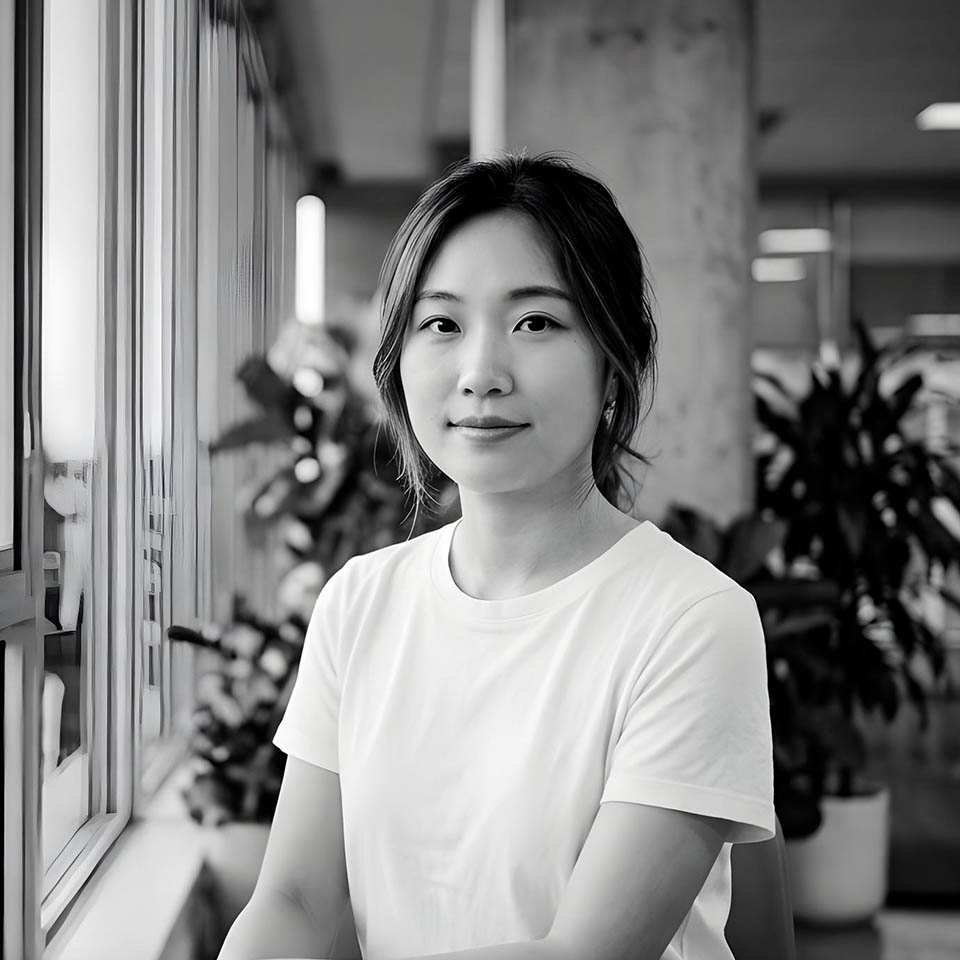 Portrait of a man with short dark hair and a trimmed beard, dressed in a dark shirt, on a simple background.
