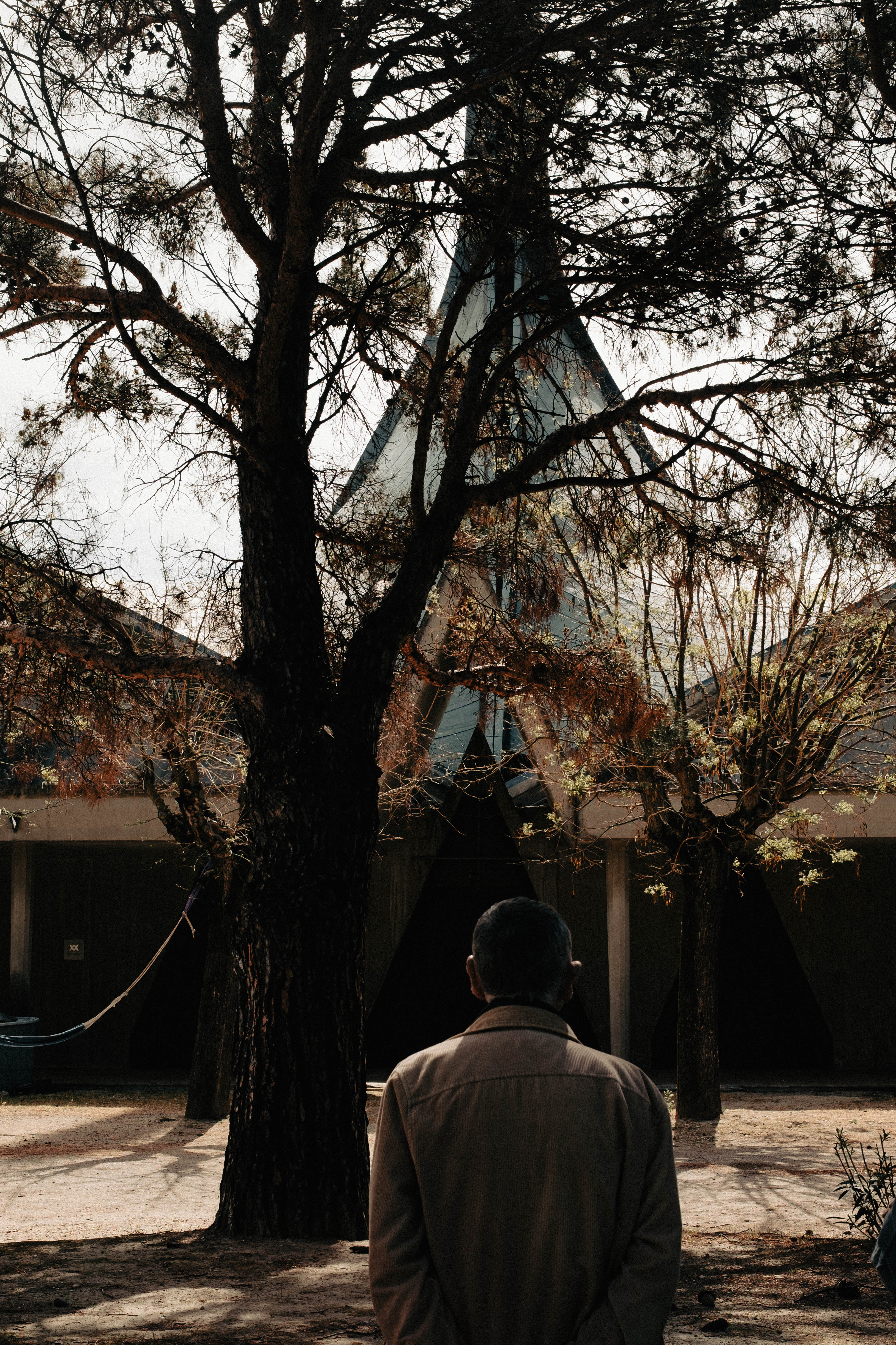 A man standing in front of a brutalist church