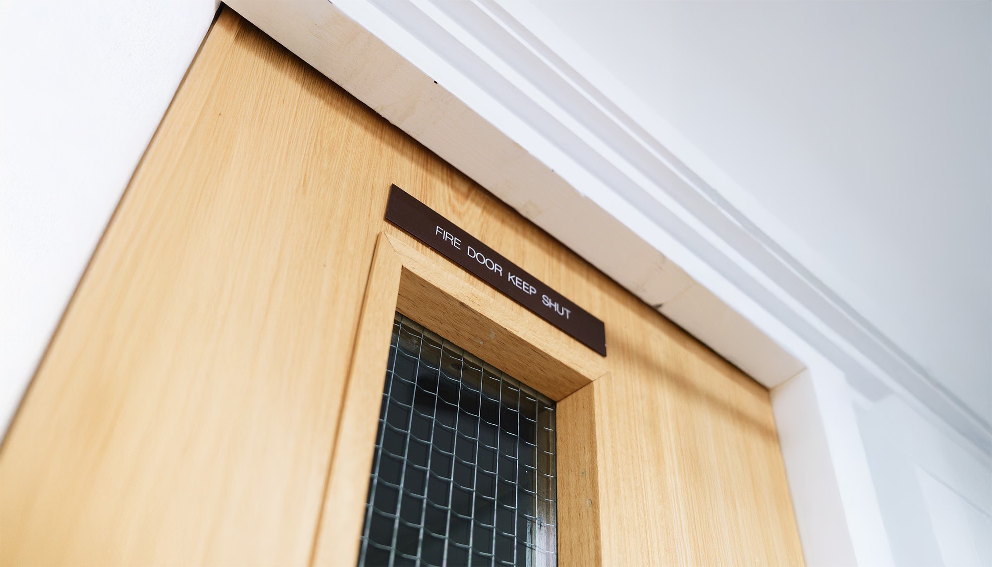 Fire door with keep shut sign in a commercial building