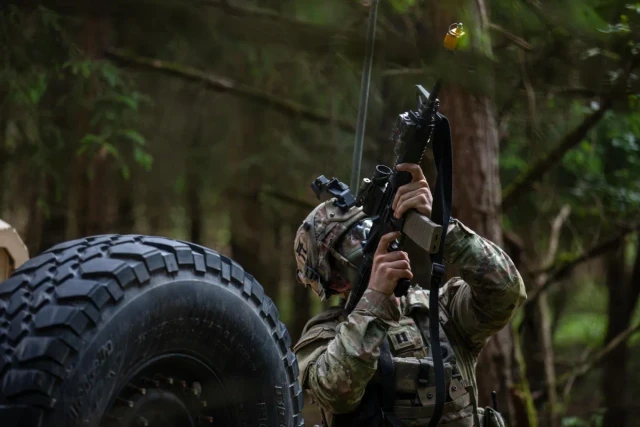 Infantry Soldiers under a quadcopter drone, reacting to an unmanned aircraft system