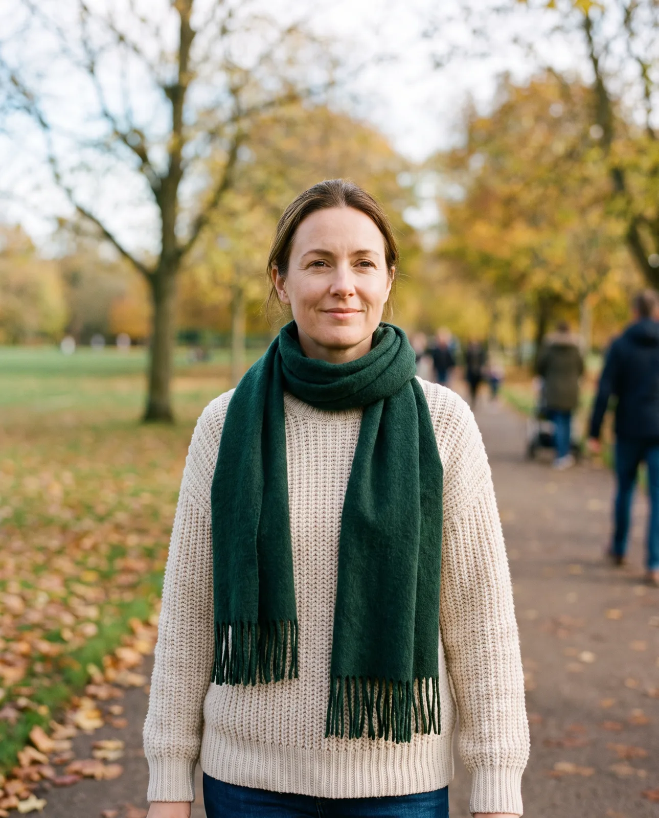 Woman walking through a park on an autumn afternoon