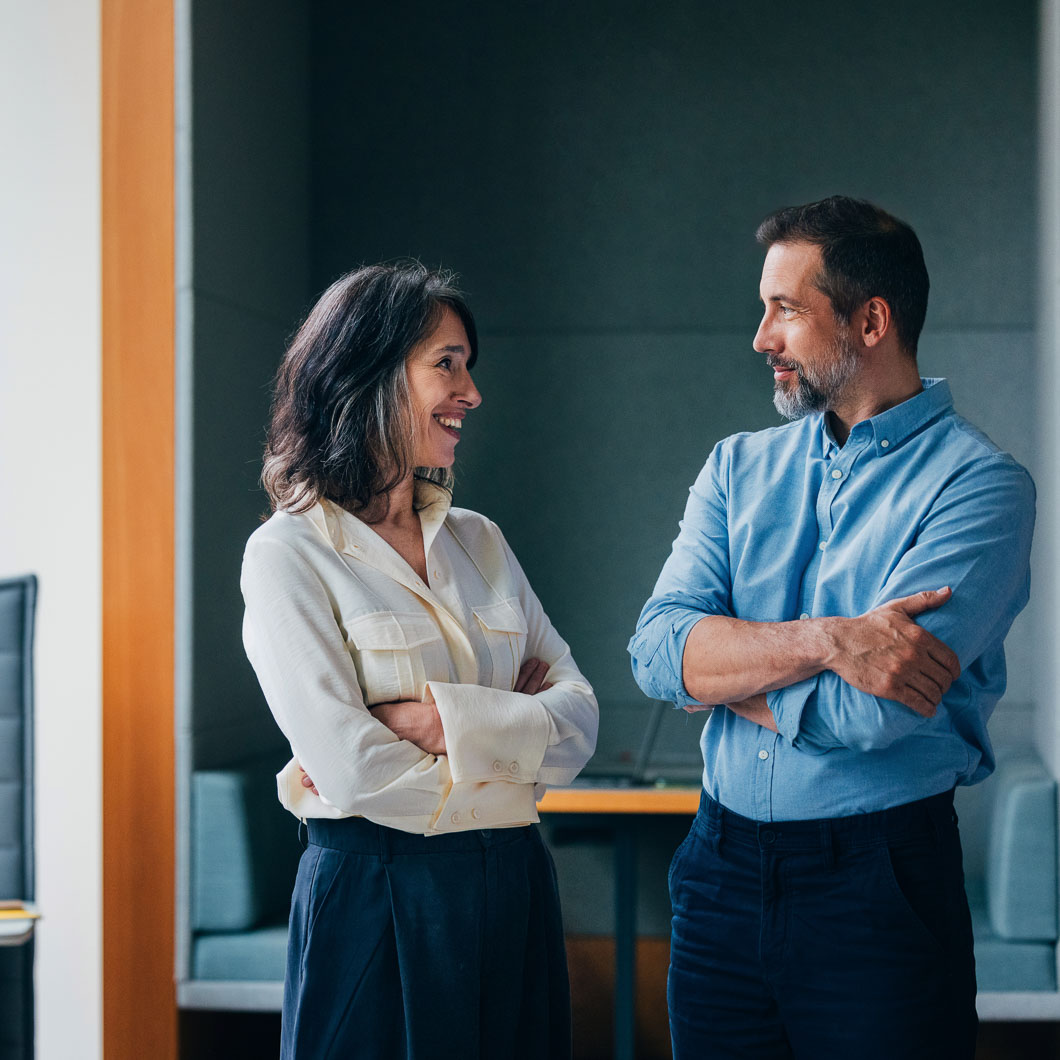 E3 visa lawyer discussing case with colleague in office