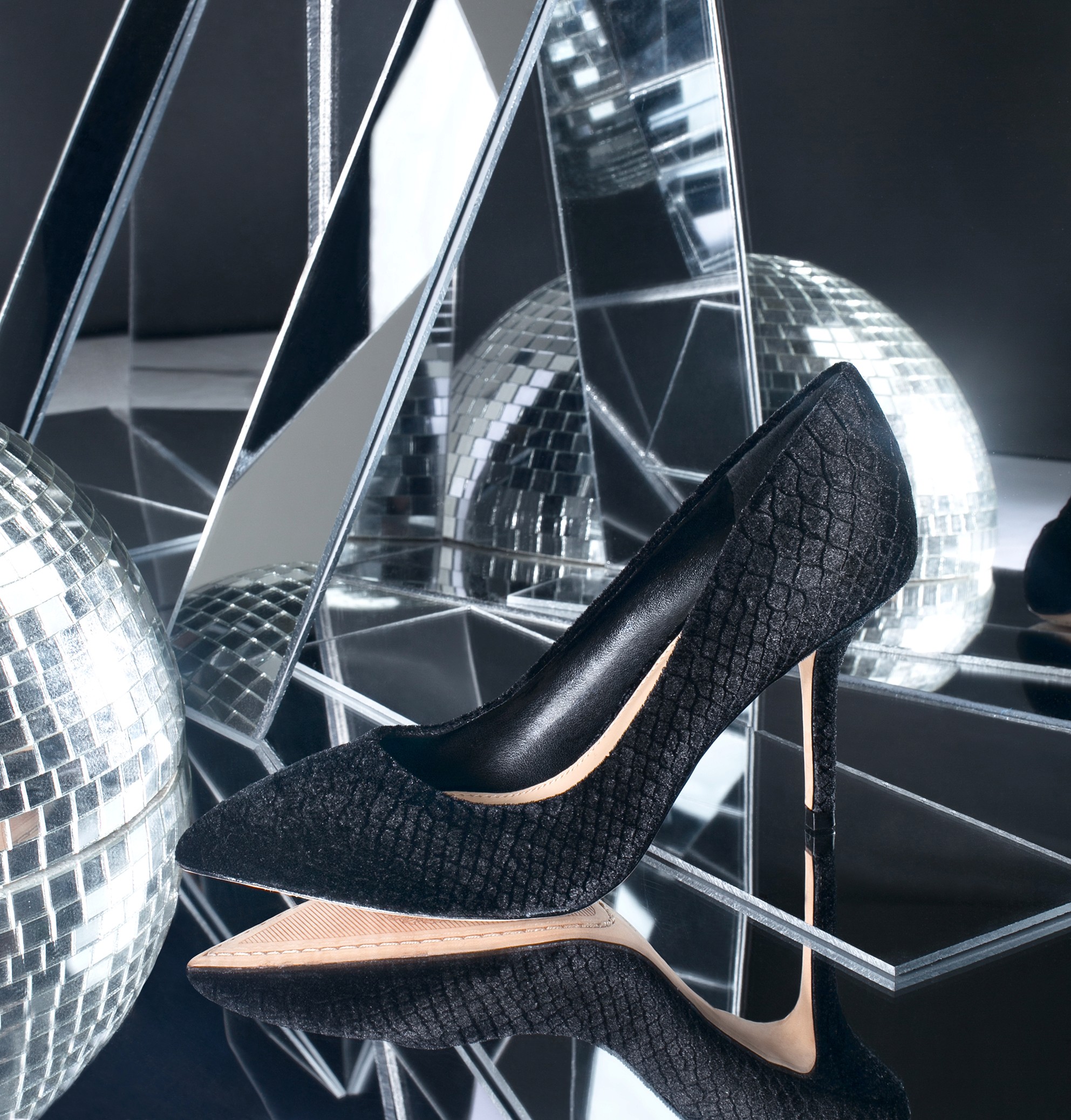 Black Vince Camuto heel from La Favorita Shoes displayed among mirrored geometric shapes and disco balls.