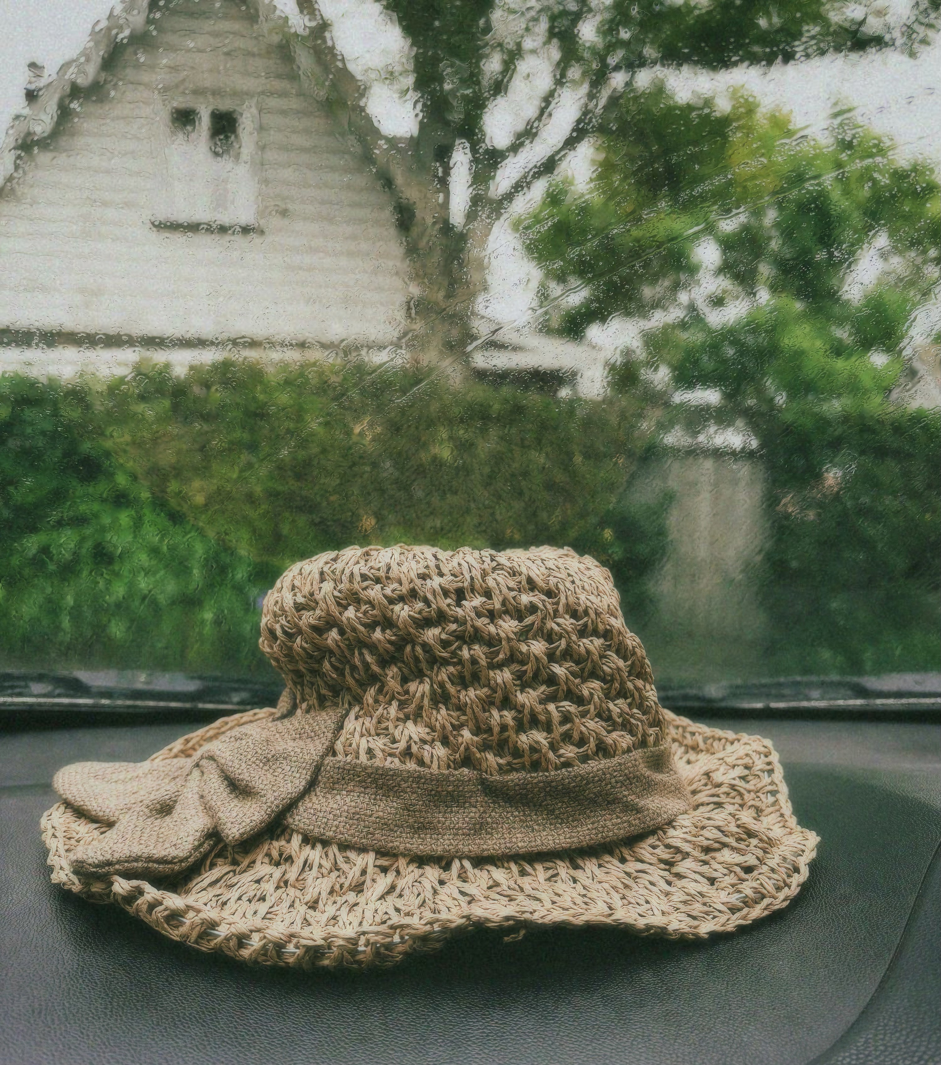 Close-up of a yellow tennis ball sitting on a green court, positioned near the white center line.