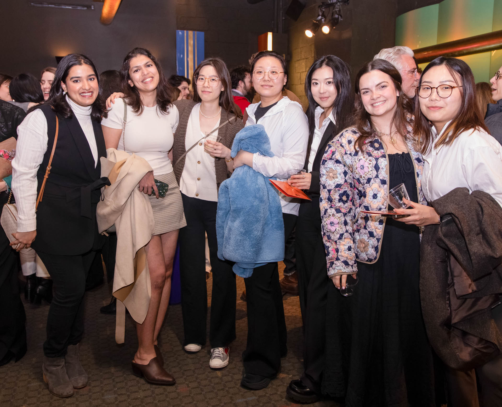 a group of students smiling for the camera in the SVA Theatre lobby after the Venture Forum
