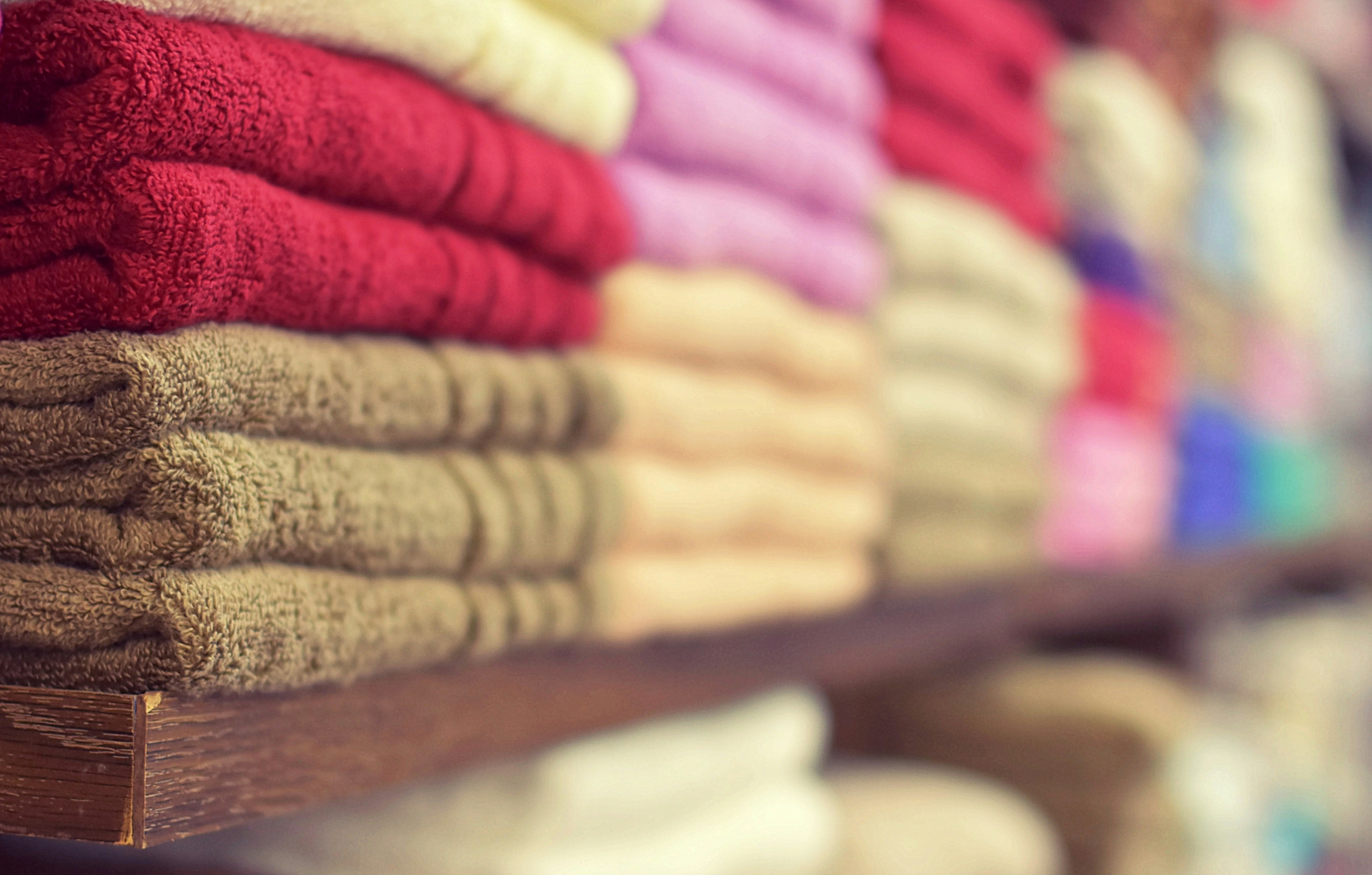 Shelves of folded towels in bright colors