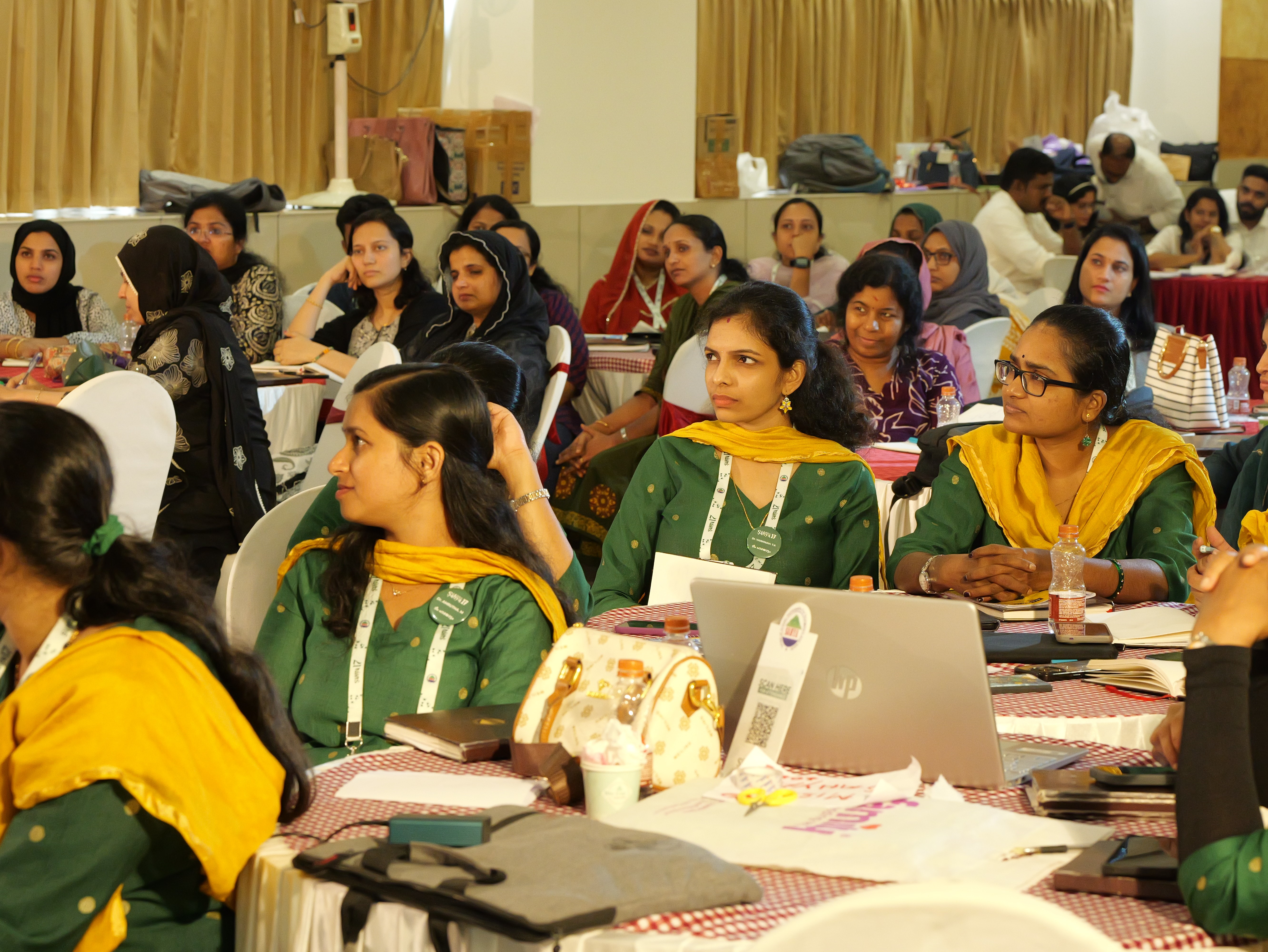 Winding road through a forest towards mountains.