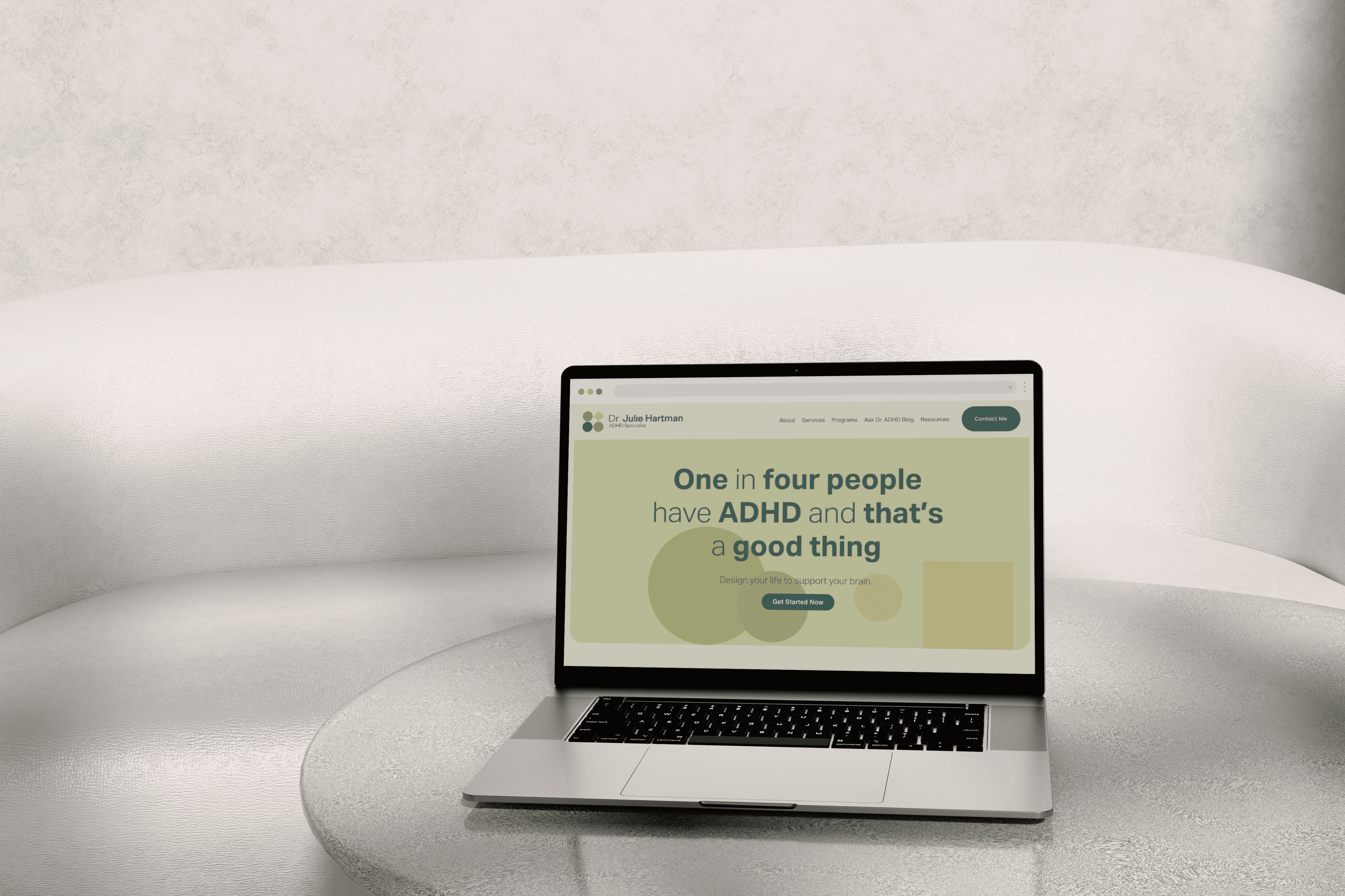 Image of one-in-four.com mockup on a laptop setup