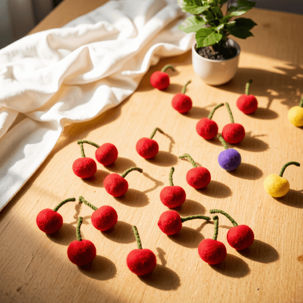 product photography of a set of cherry-shaped felt decorations