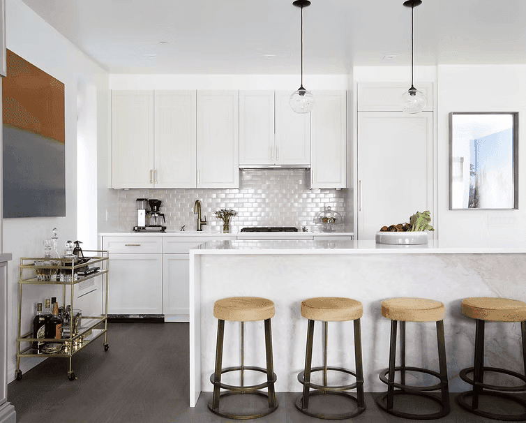 A person with short blonde hair holds a vintage camera.