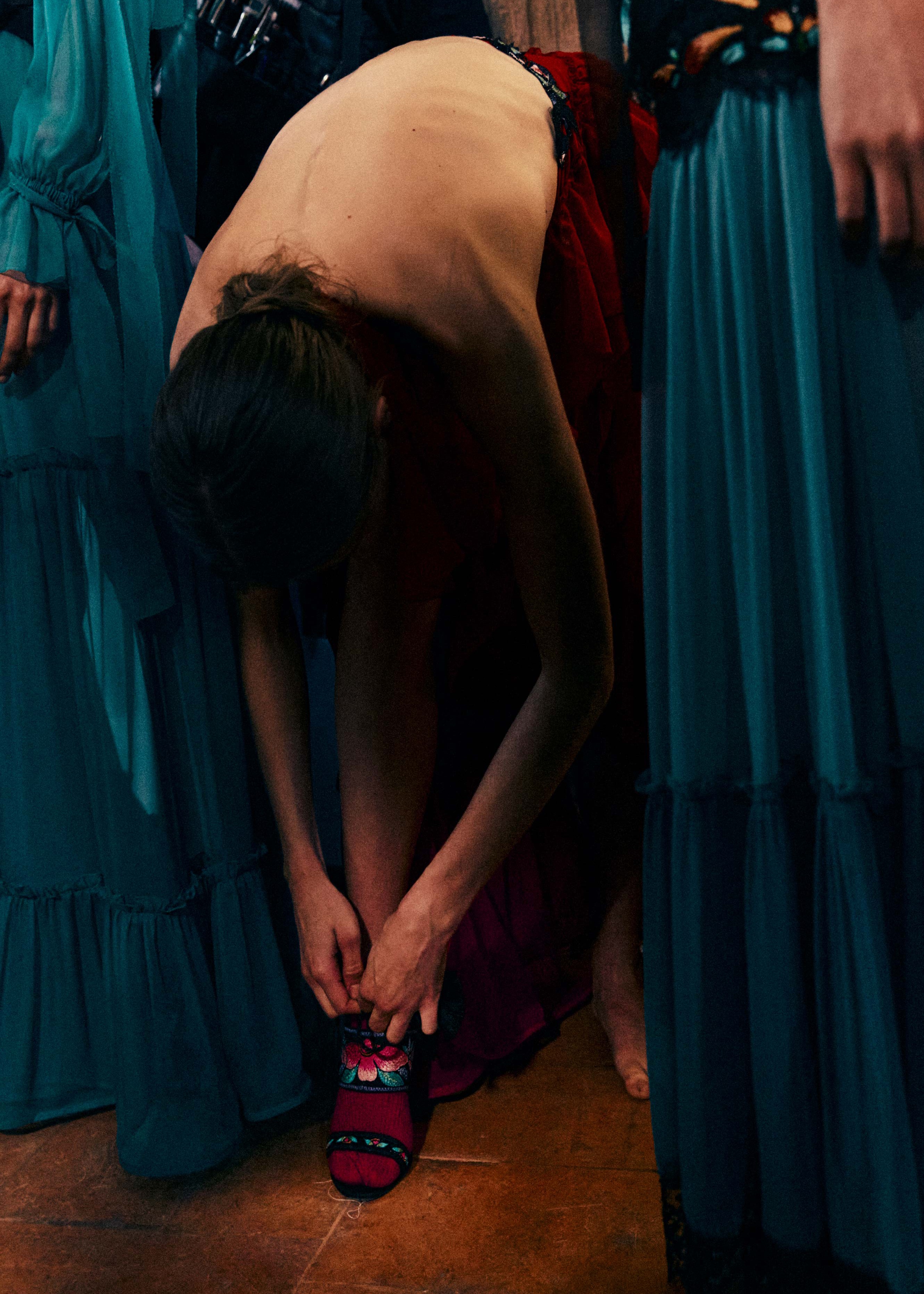 A fast black sports car races down the highway.