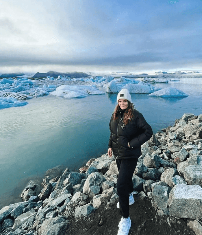Standing in from of iceberg in Iceland