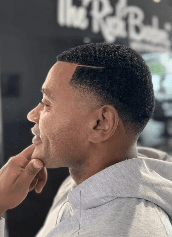 Mid taper fade with line part design, ideal for clean professional look by Courtney Palmore. The Rich Barber Hair Studio, West Hollywood, CA. Los Angeles