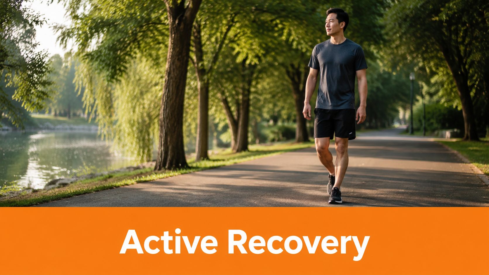 A man in athletic wear walks along a scenic path by a lake during a workout session.