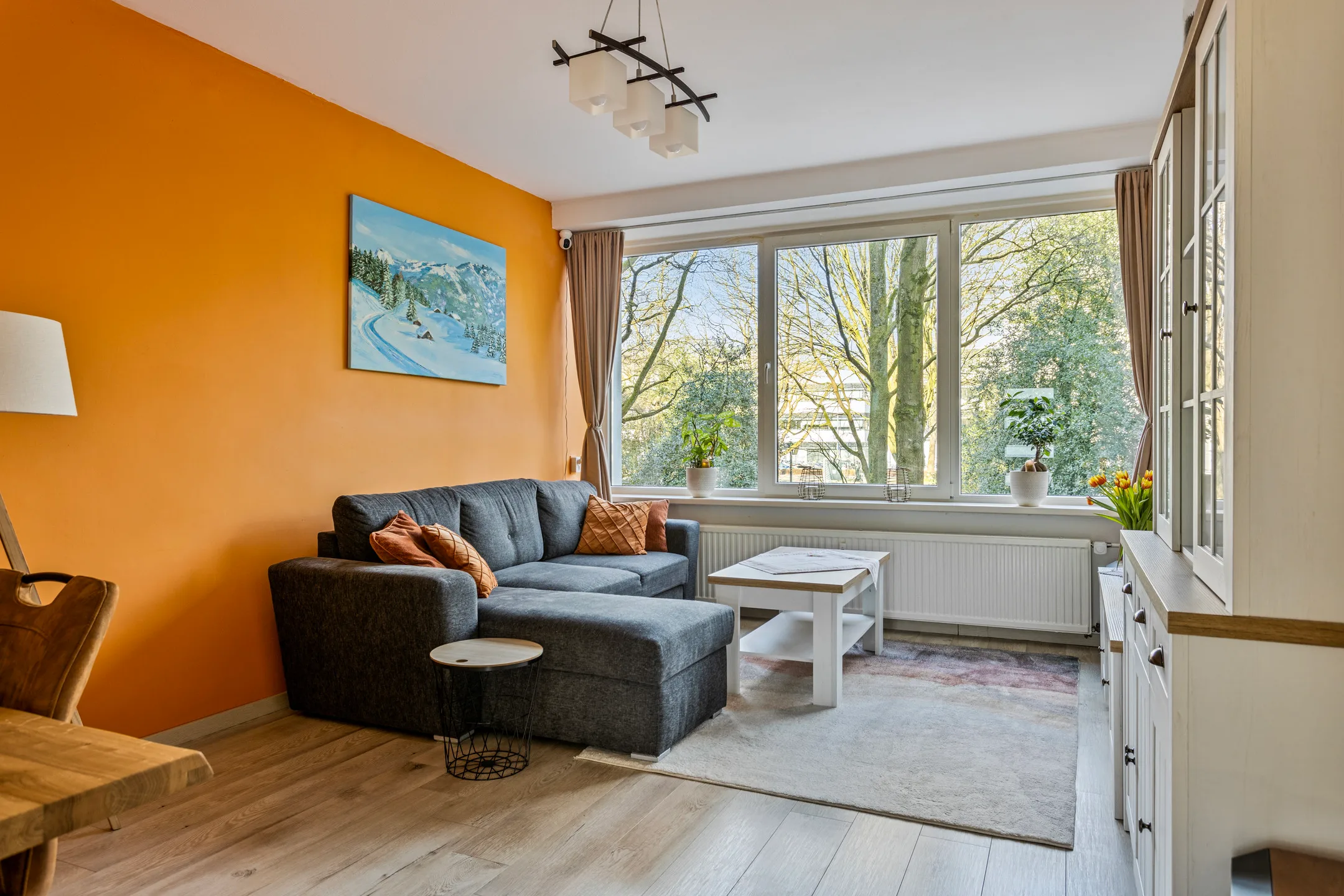 a living room filled with furniture and a large window