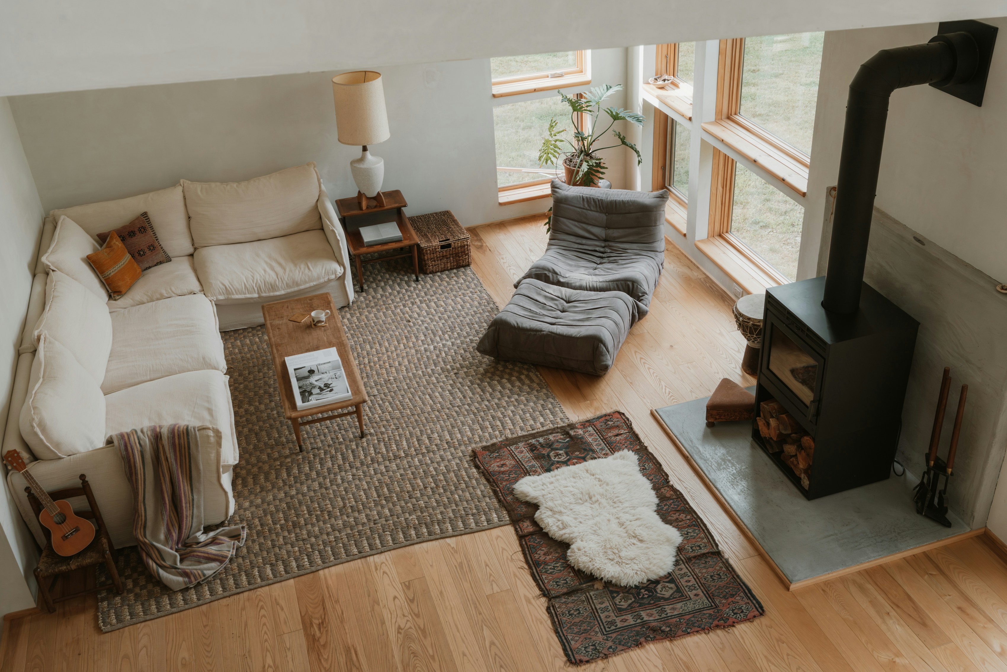 Cozy living room with sectional sofa and wood stove.