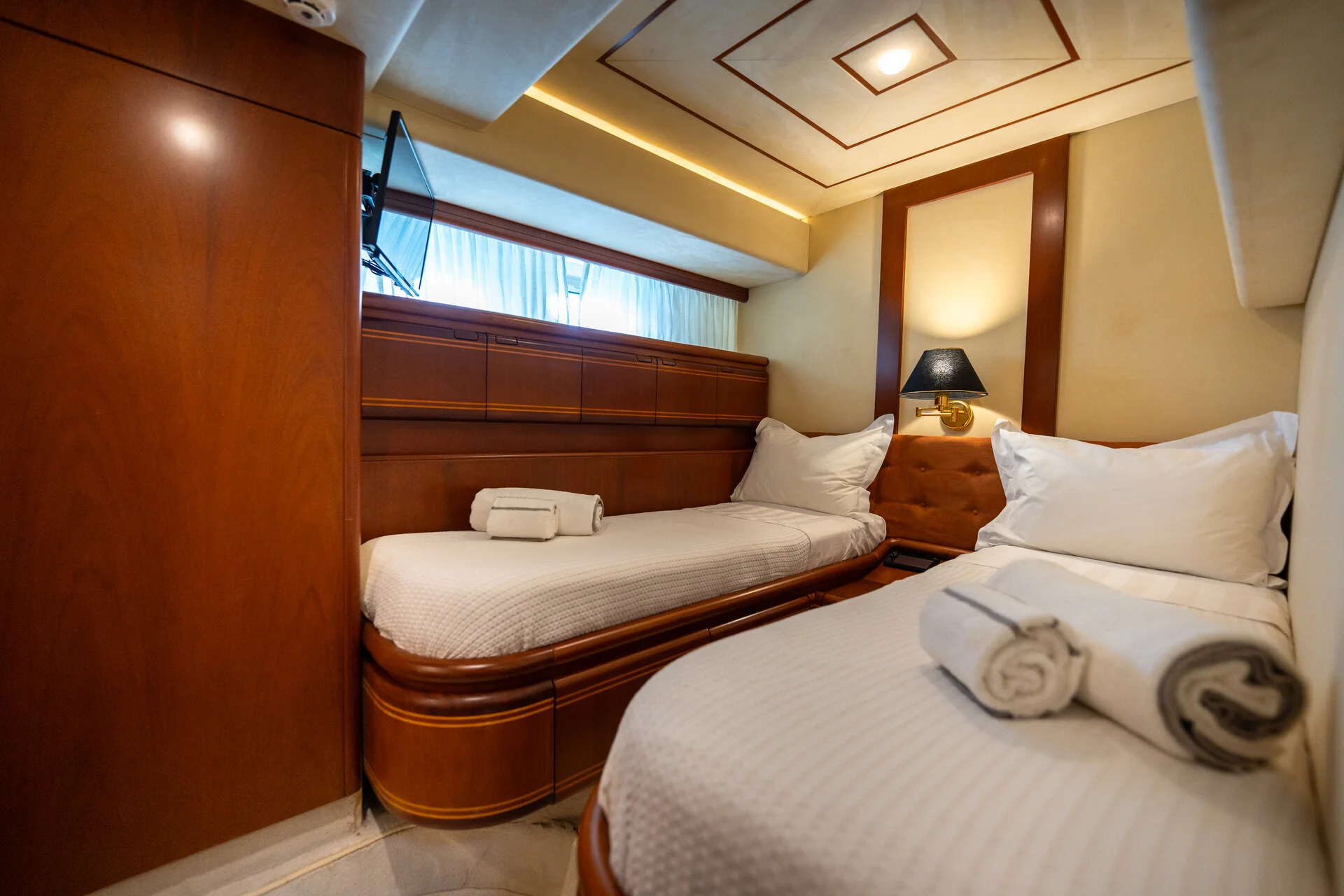 White Rock 36 speedboat with captain at helm cruising calm blue waters near Paros coastline with hills in background.