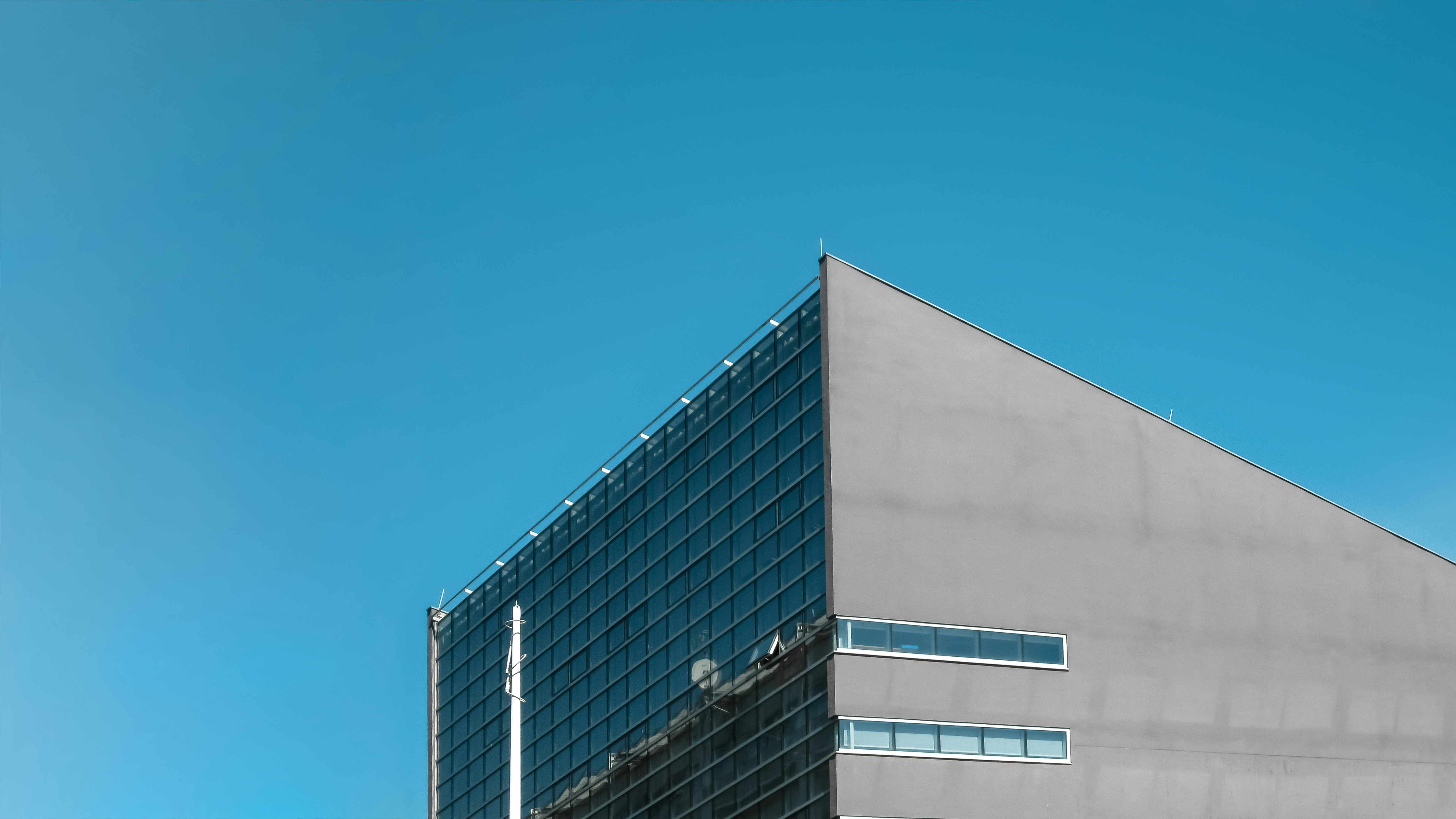 white modern cement building under blue sky