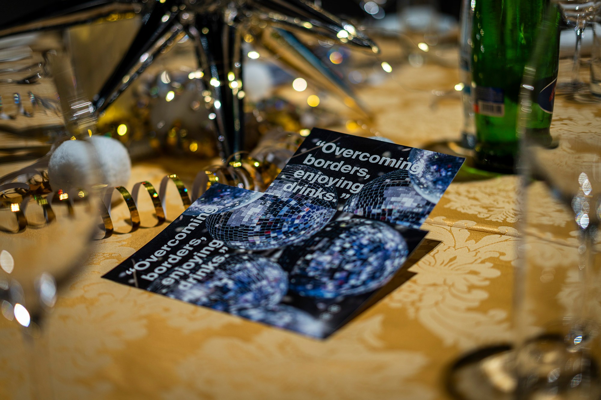 Printed gala programme with the slogan “Overcoming borders” placed on a decorated dinner table during the evening event at the CWS international sales conference in Prague.